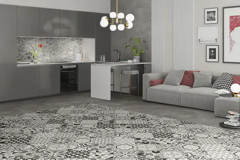 Cucina a vista con penisola e soggiorno, una zona di cementine grigie decorate posata come un tappeto